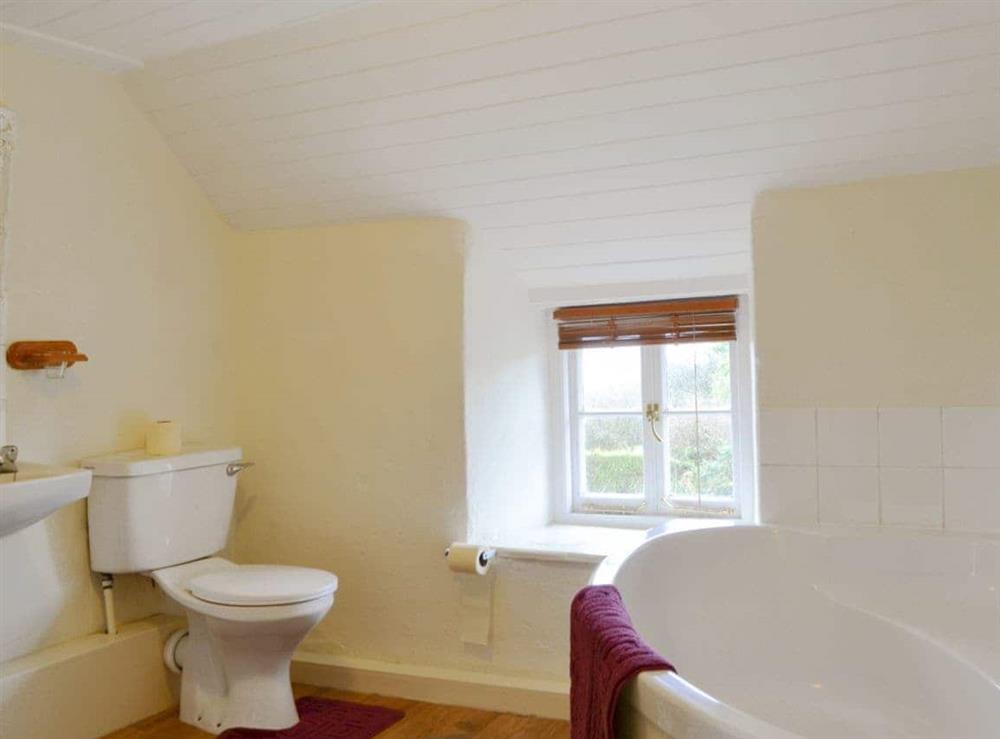 Bathroom with corner bath at Mulberry Cottage in Acton, near Langton Matravers, Dorset