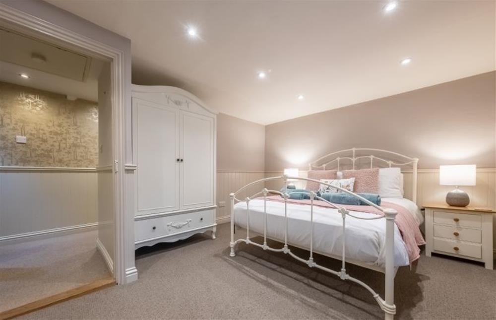 Bedroom two, with double bed and wardrobe at Mulberry Cottage, Holt