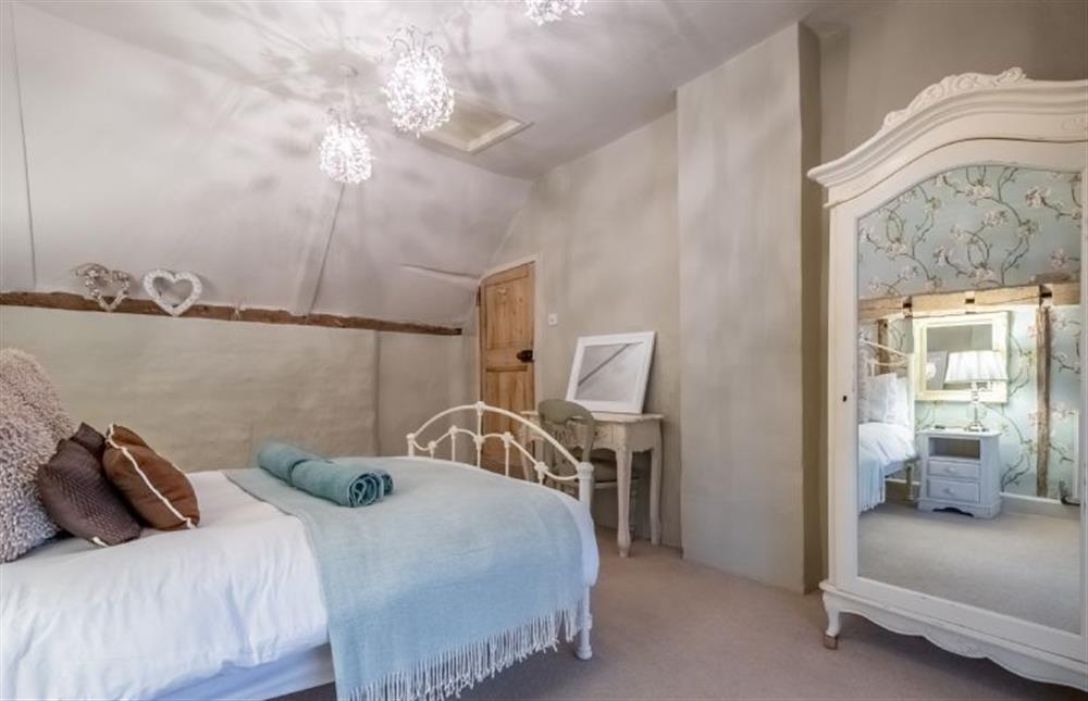 The master bedroom has a wardrobe at Mulberry Cottage, Holt