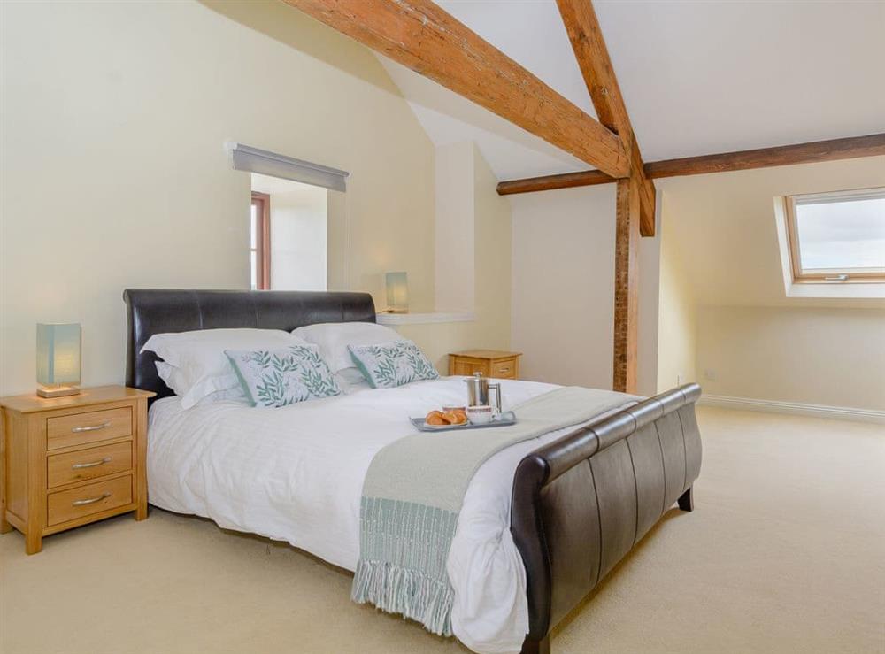 Exposed wood beams within the en-suite double bedroom at Mulberry Cottage in North Wooton, near Wells, Somerset