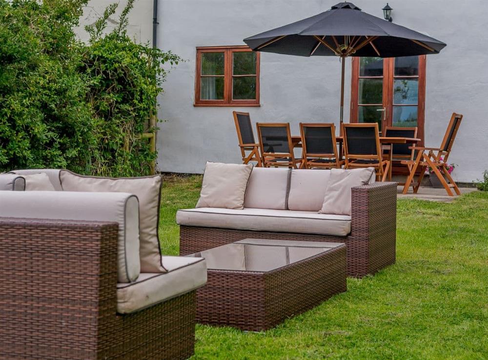 Garden furniture upon the lawned garden at Mulberry Cottage in North Wooton, near Wells, Somerset