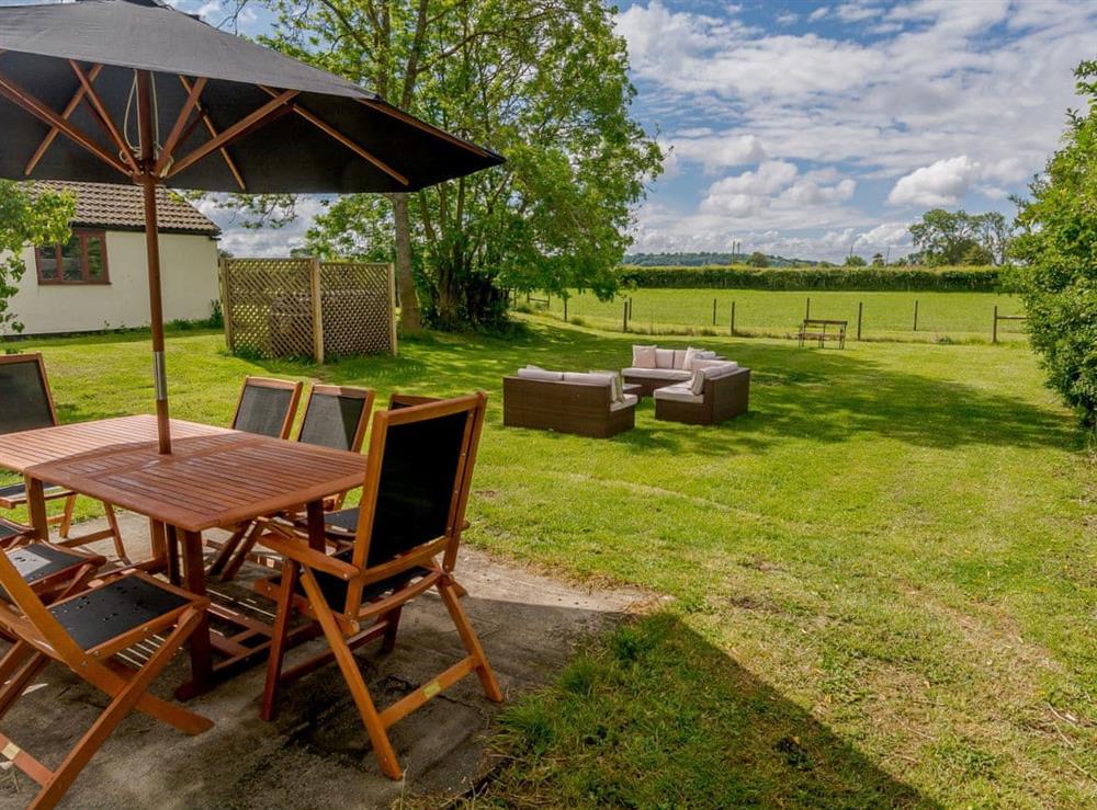 Paved patio area with outdoor furniture at Mulberry Cottage in North Wooton, near Wells, Somerset