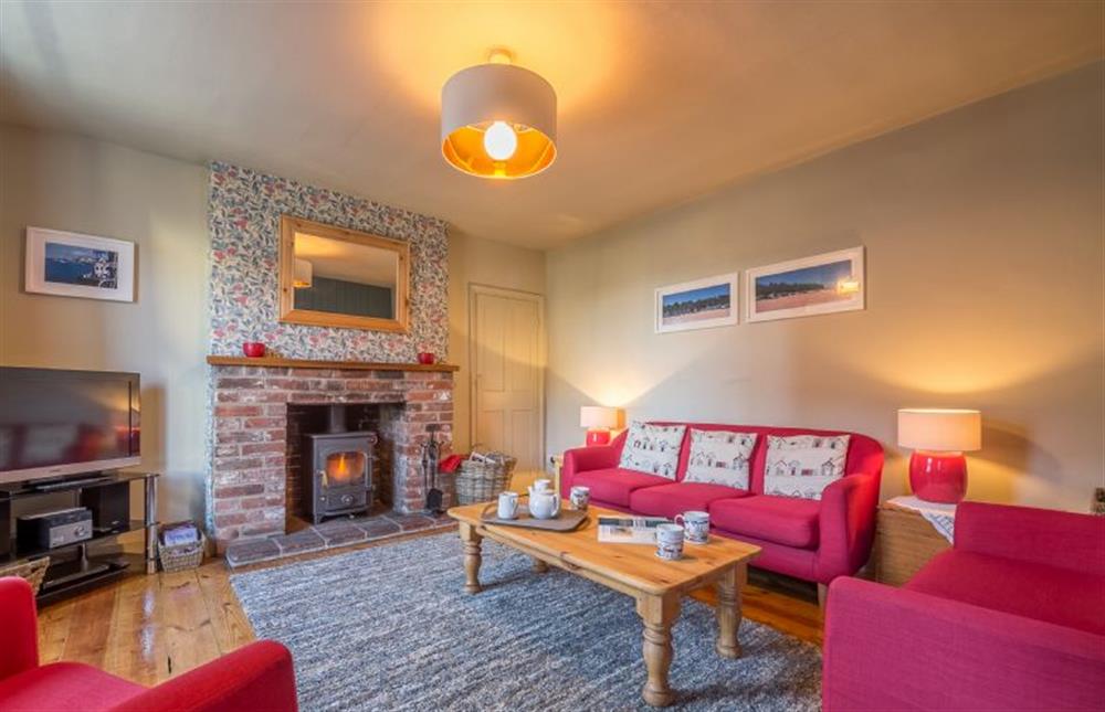 Ground floor: Sitting room with feature fireplace with wood burning stove (photo 2) at Mulberry Cottage, Wells-next-the-Sea