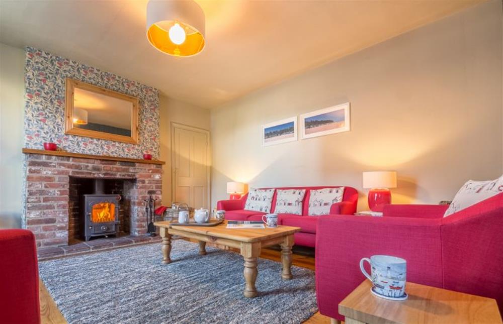 Ground floor: Sitting room with feature fireplace with wood burning stove at Mulberry Cottage, Wells-next-the-Sea