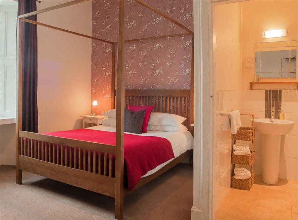 Four poster double bedroom with en-suite shower room at Munros in Rothesay, Isle of Bute, Argyll and Bute, Scotland