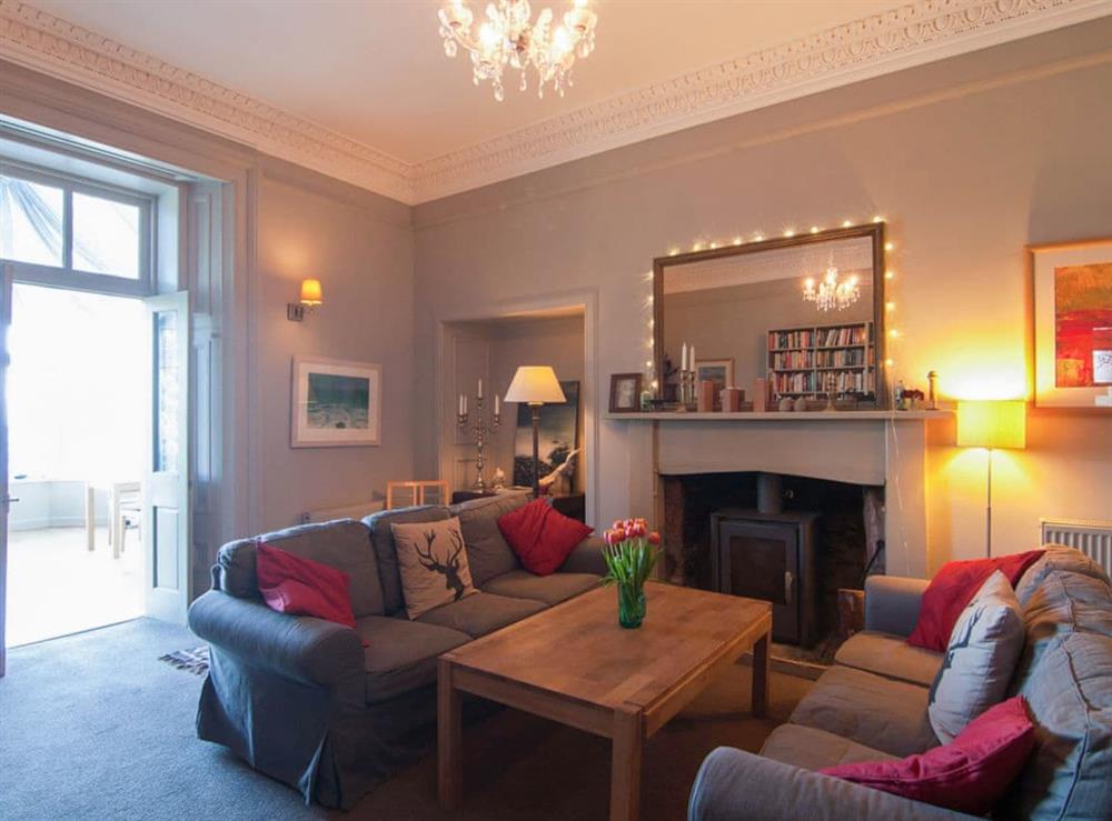 Warm and cosy living room with woodburner at Munros in Rothesay, Isle of Bute, Argyll and Bute, Scotland