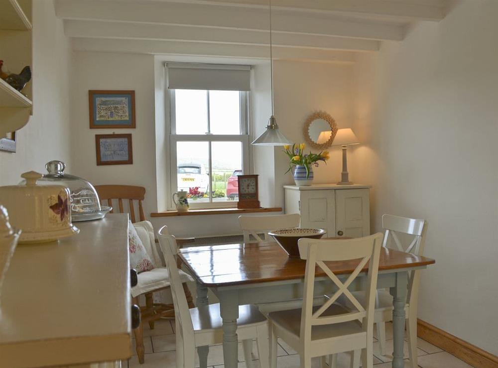 Beautifully decorated kitchen/dining area with dining table and chairs at Mur Llwyd in Rhoshirwaun, near Pwllheli, Gwynedd