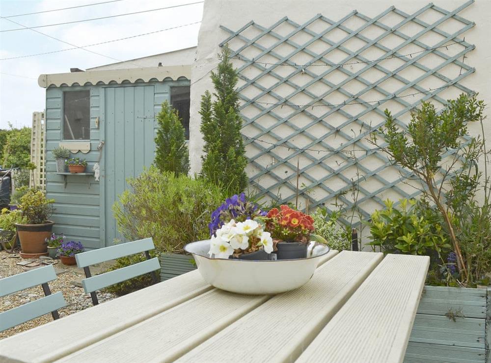 Courtyard with garden furniture and BBQ at Mur Llwyd in Rhoshirwaun, near Pwllheli, Gwynedd