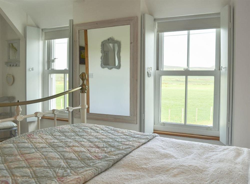 Elegantly furnished bedroom with double bed at Mur Llwyd in Rhoshirwaun, near Pwllheli, Gwynedd