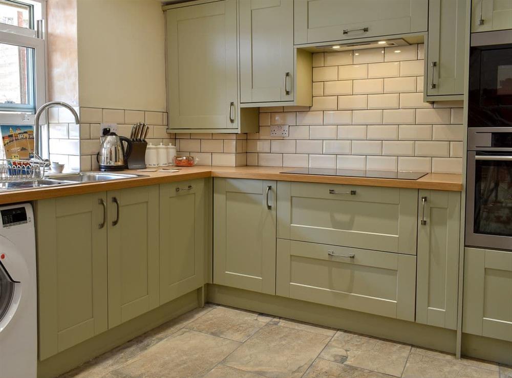 Well-equipped kitchen with dining area (photo 2) at Murmuration Cottage in Whitby, North Yorkshire
