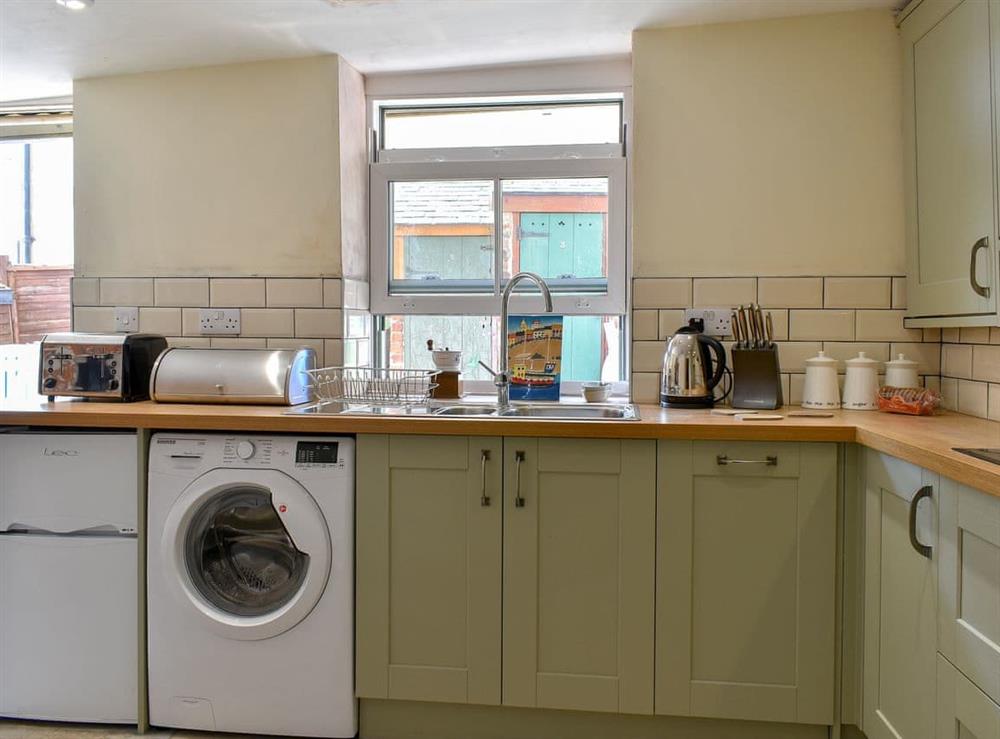 Well-equipped kitchen with dining area (photo 3) at Murmuration Cottage in Whitby, North Yorkshire