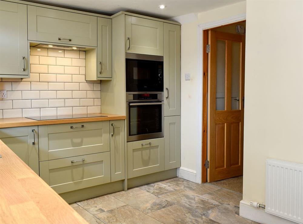 Well-equipped kitchen with dining area at Murmuration Cottage in Whitby, North Yorkshire