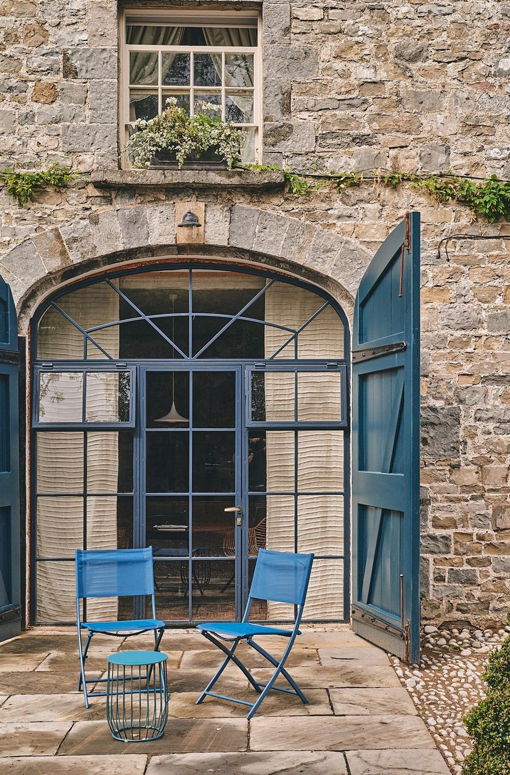 The table and chairs outside the entrance