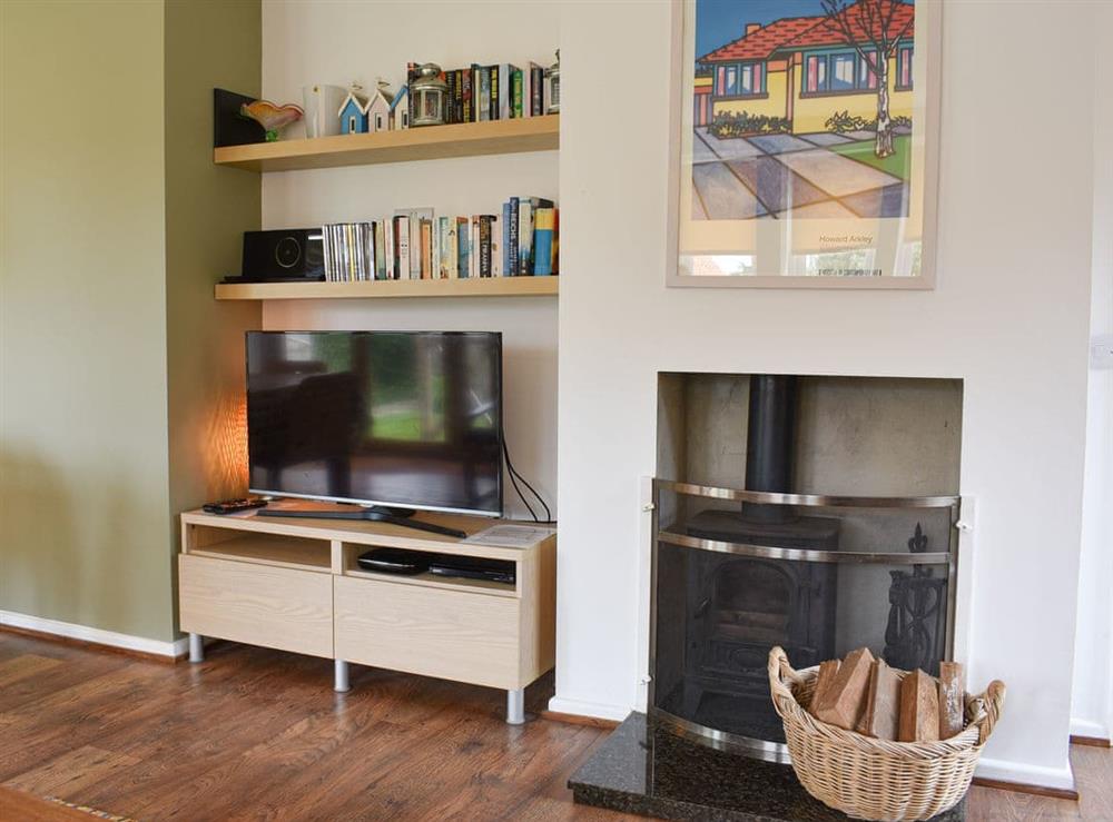 Living room with wood burner at Mussel Cottage in Elmer, West Sussex