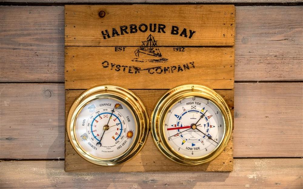 Nice nautical touches have been included like this brass clock and barometer.  at Mussels in Helford Passage
