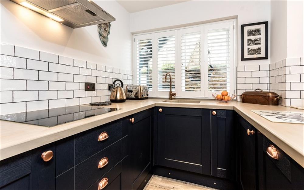 Plenty of room to prepare delicious meals in this spacious kitchen.  The appliances are  integrated within the navy blue units. at Mussels in Helford Passage