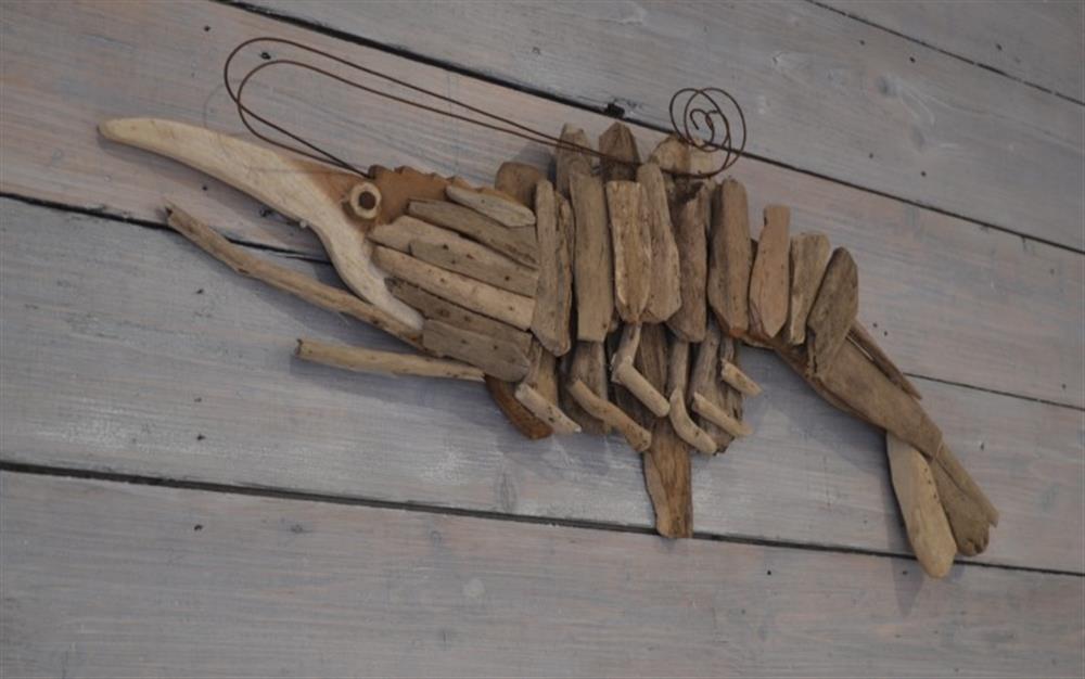 Very effective driftwood art work in the form of a prawn.