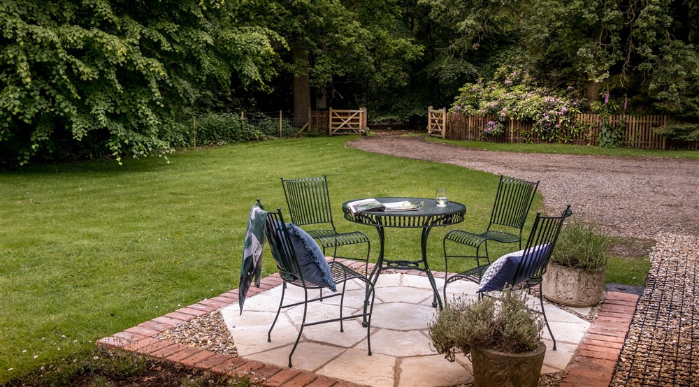 The patio in the garden of Mustard Pot Cottage, with outdoor dining furniture, Norfolk at Mustard Pot Cottage in Norwich, Norfolk