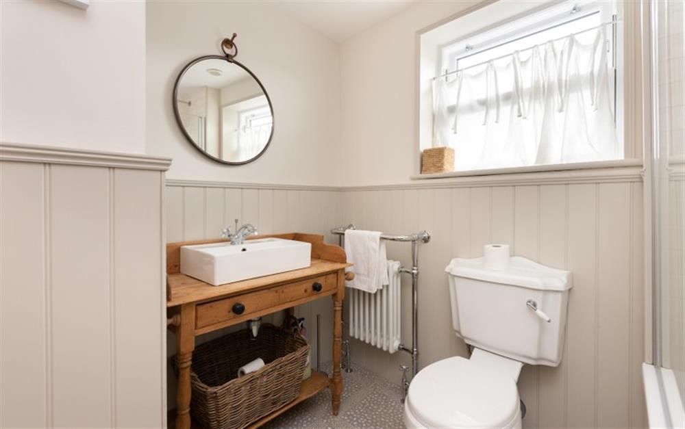 The family bathroom with beautiful vintage style sink and pattern tiled floor. at Myrtle Cottage in Kingsbridge