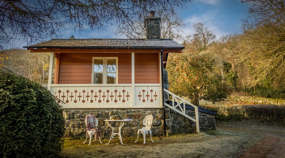 The exterior of Nant Las with outdoor table and chairs for two, Gwynedd at Nant Las in Dolgellau, Gwynedd