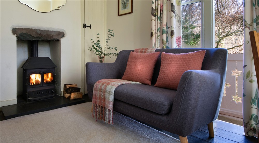 The sitting room with comfortable places to sit by the woodburner, Nant Las, Gwynedd at Nant Las in Dolgellau, Gwynedd