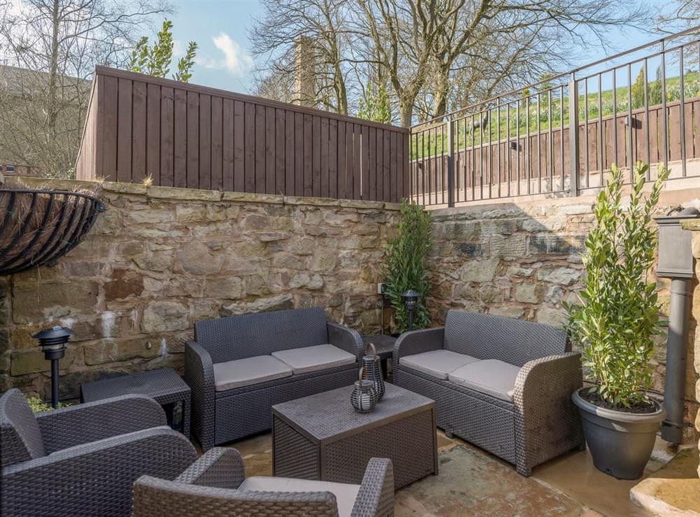 Sheltered area of patio with high quality outdoor furniture at Narrowgates Cottage in Barley, near Barrowford, Lancashire, England