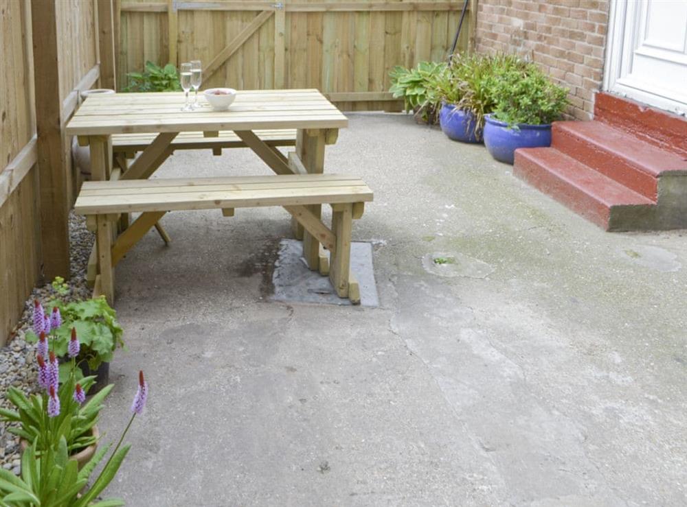 Additional outdoor seating within enclosed courtyard at Naters Apartment in Cullercoats, near Whitley Bay, Tyne and Wear