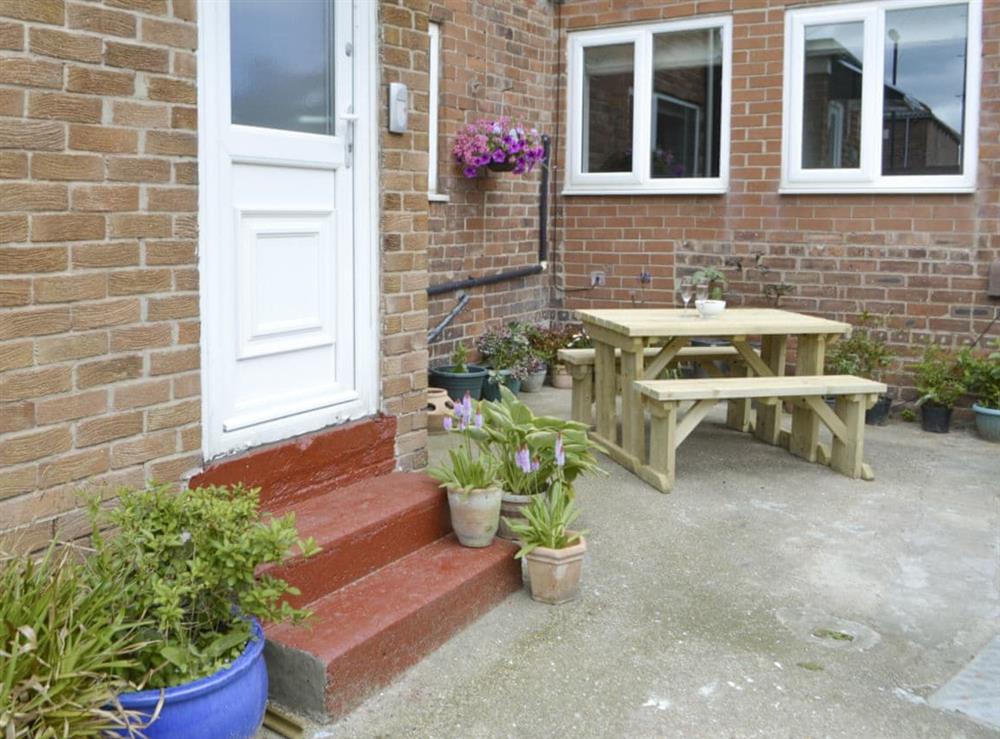 Attractive courtyard with outdoor furniture at Naters Apartment in Cullercoats, near Whitley Bay, Tyne and Wear