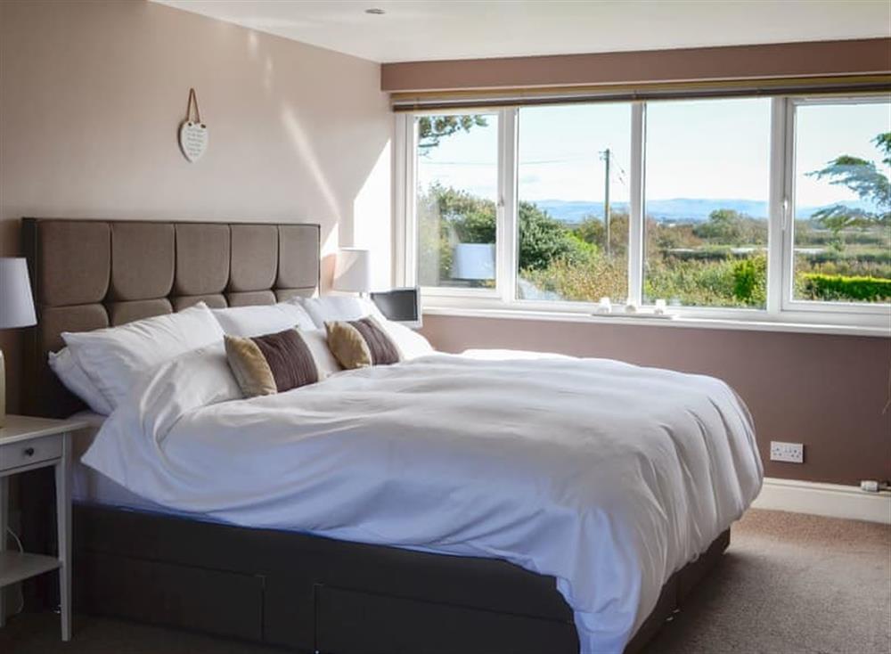 Comfortable bedroom with super kingsize bed at Neeprig in Skinburness, near Silloth, Cumbria