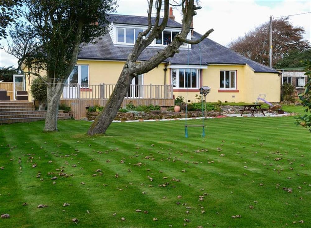 Large lawned garden with patio and garden furniture (photo 2) at Neeprig in Skinburness, near Silloth, Cumbria