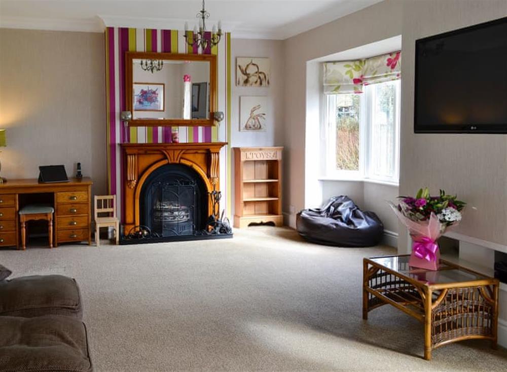 Spacious living room with wood burner at Neeprig in Skinburness, near Silloth, Cumbria