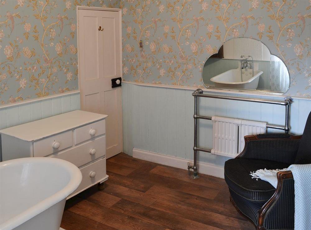 Elegant bathroom with heated towel rail and shower attachment at Nells Cottage in Bridlington, North Humberside