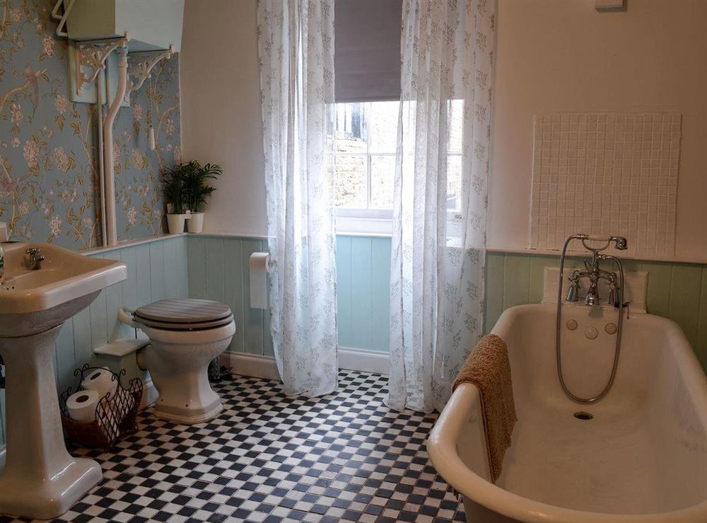 Luxurious bathroom with roll top bath at Nells Cottage in Bridlington, North Humberside