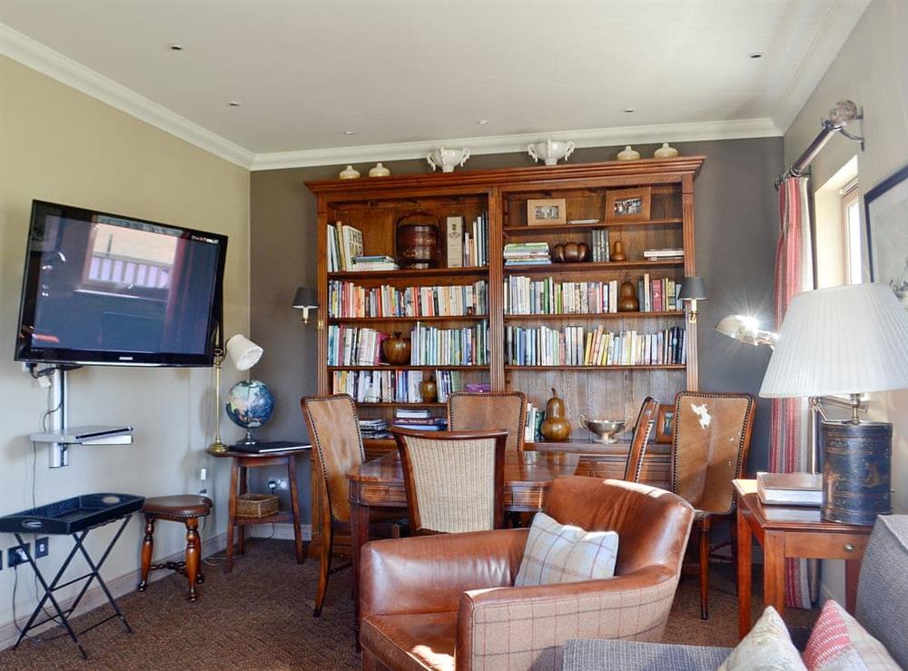 Cosy library area with TV at River Lodge, 