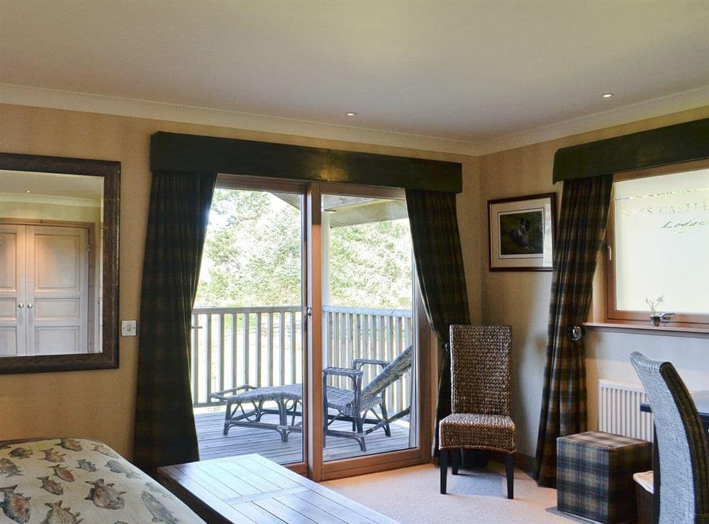 Luxurious double bedroom with patio doors onto the balcony at River Lodge, 