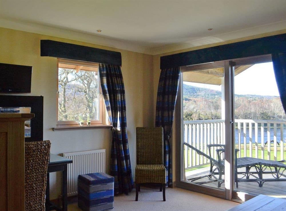 Sylish double bedroom with patio doors leading onto a balcony at River Lodge, 