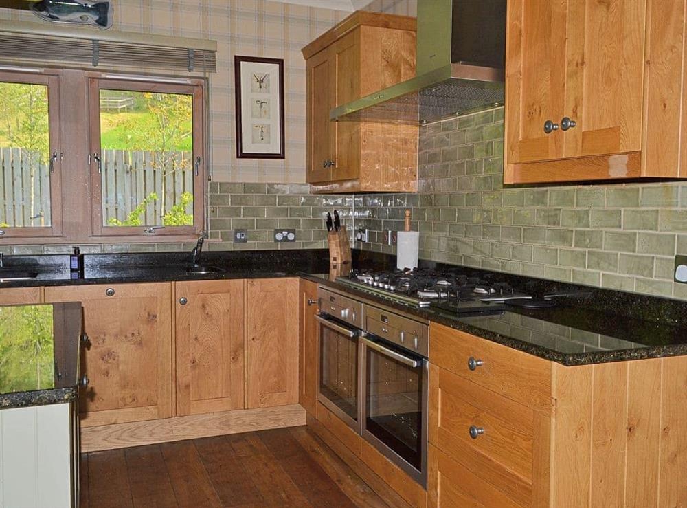 Well-equipped kitchen with wooden floor (photo 2) at River Lodge, 