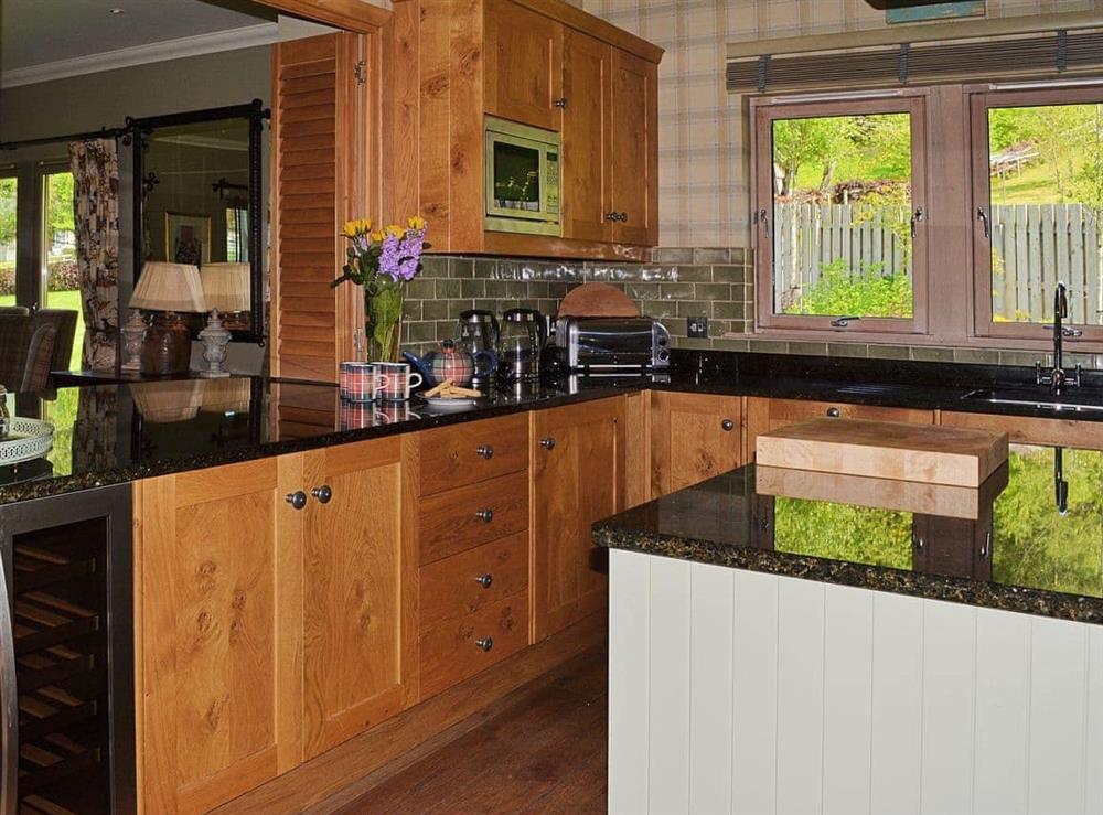 Well-equipped kitchen with wooden floor at River Lodge, 