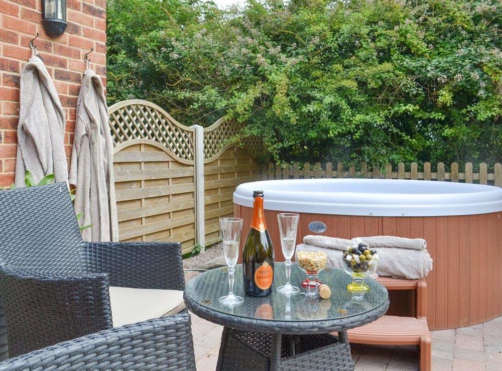 Attractive patio area with luxurious hot tub at Nesting Box in Chapel-St-Leonards, Lincolnshire