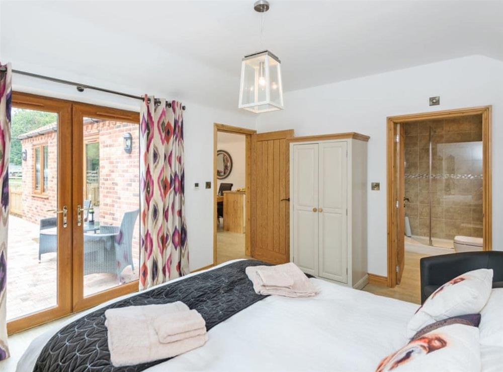 Luxurious double bedroom with French doors leading to garden (photo 3) at Nesting Box in Chapel-St-Leonards, Lincolnshire