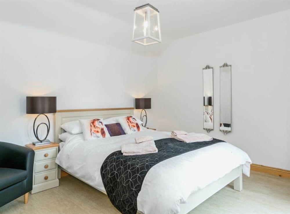 Luxurious double bedroom with French doors leading to garden at Nesting Box in Chapel-St-Leonards, Lincolnshire