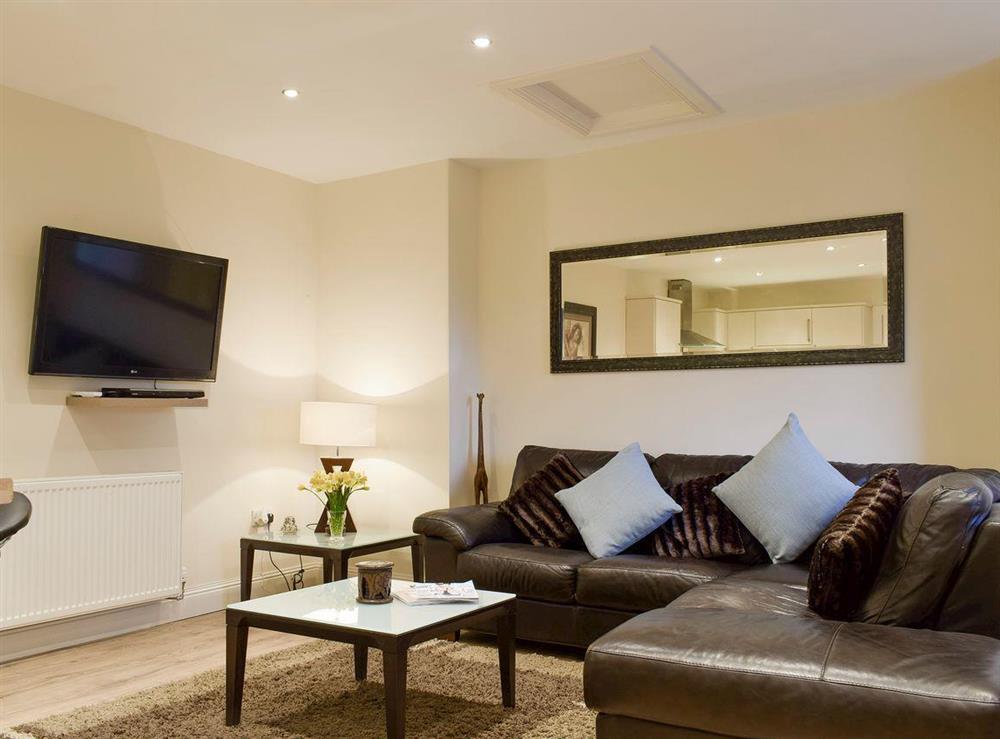 Stylish living area of open-plan living space at Kinneddar Cottage, 
