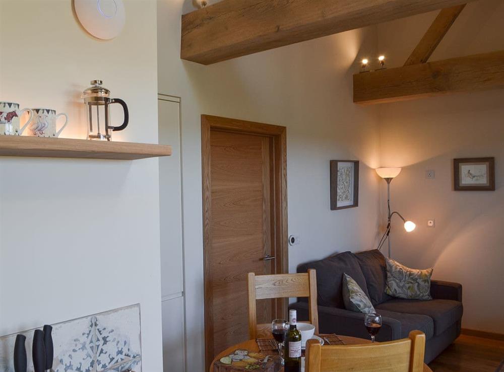 Open plan living space with wood burner (photo 3) at The Hayloft, 