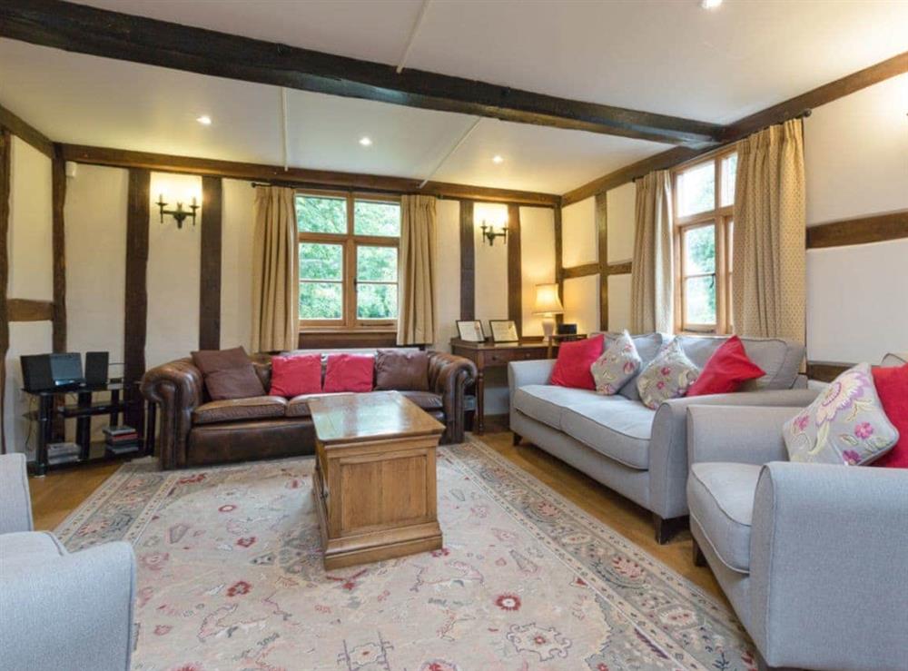 Spacious living room with exposed wood beams throughout at Brook House, 