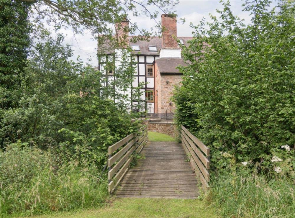 Wooden bridge connects property to surrounding countryside at Brook House, 
