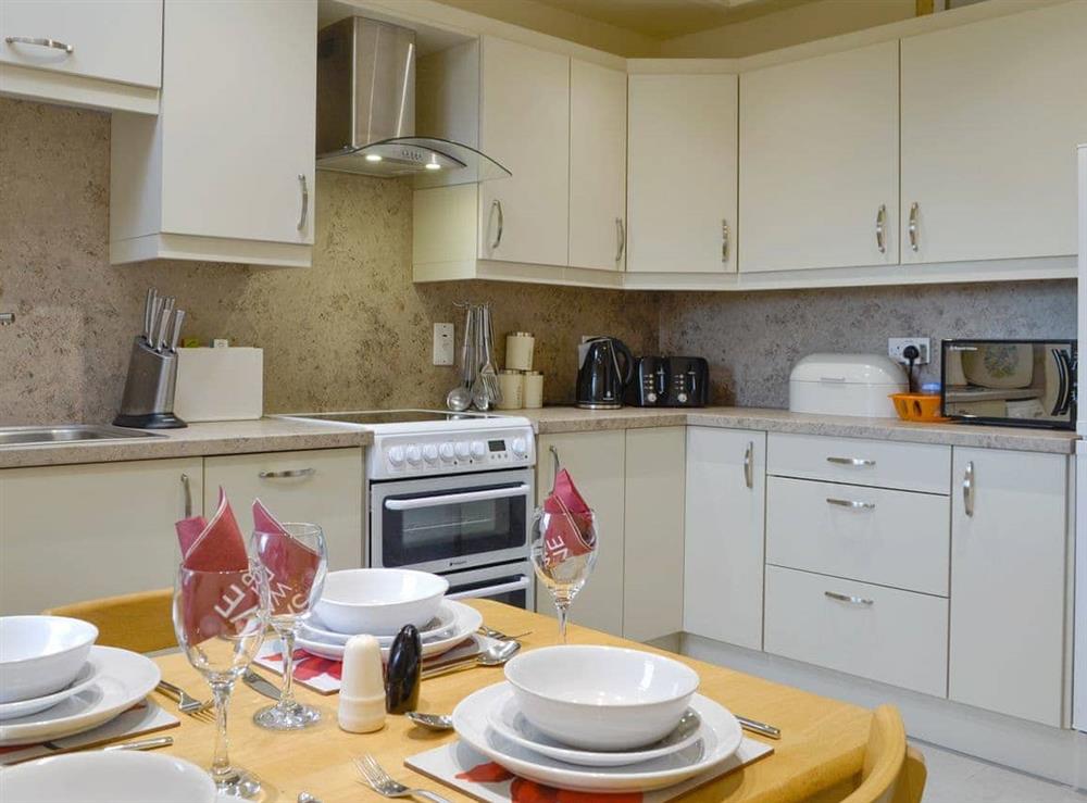 Fully appointed fitted kitchen with dining area at Mill Shore Cottage, 