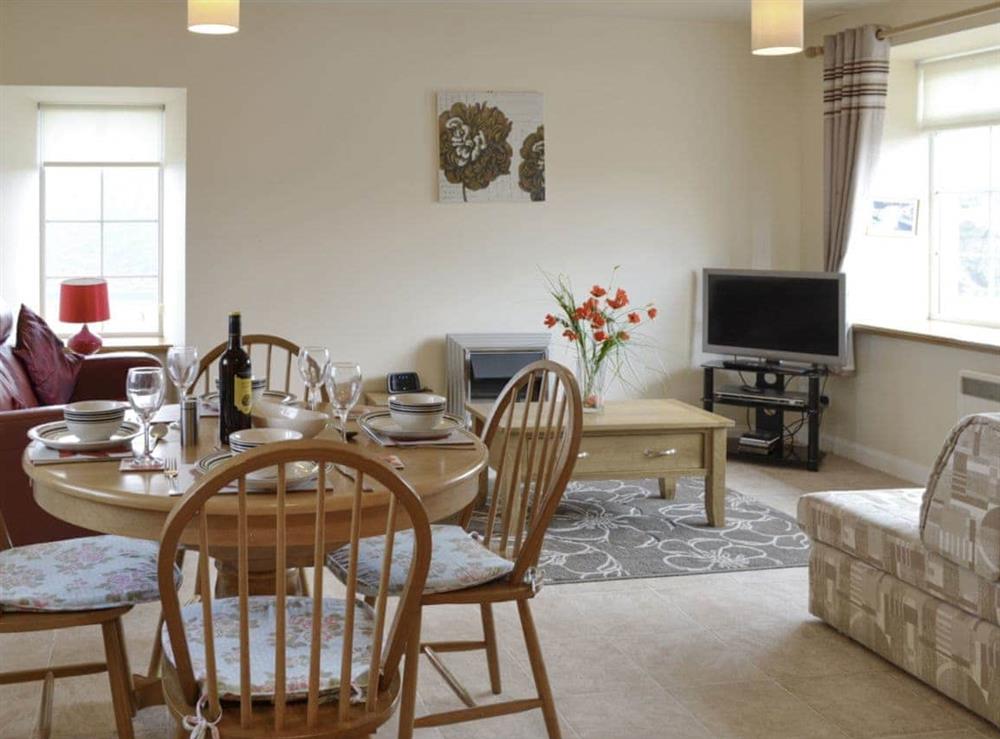 Convenient dining area within an open plan living space at Pennan Lodge, 