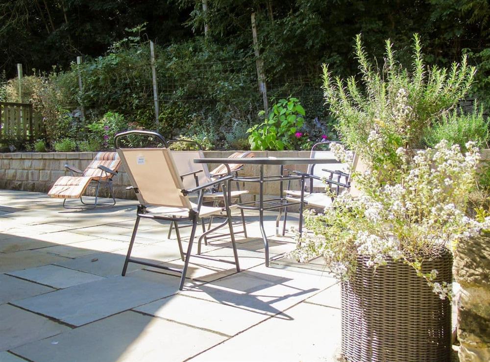 Enclosed patio with garden furniture and BBQ at Netherwood in Bakewell, Derbyshire