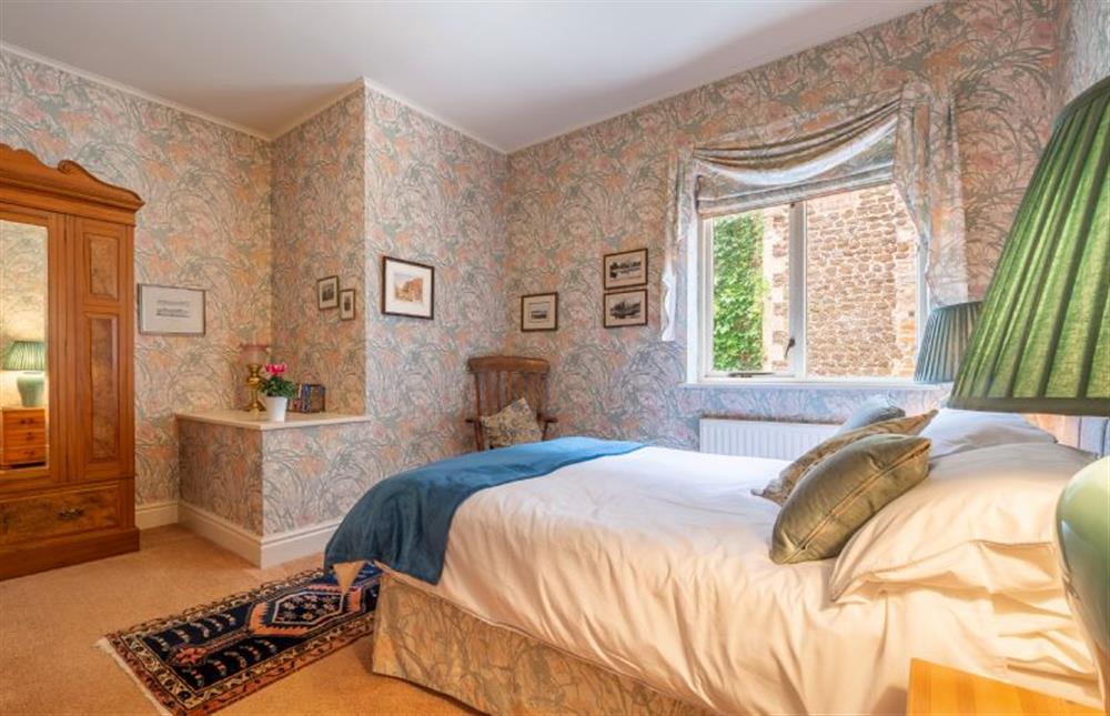 First floor:  Prettily decorated in chintz prints, this property is served by the first floor bathroom