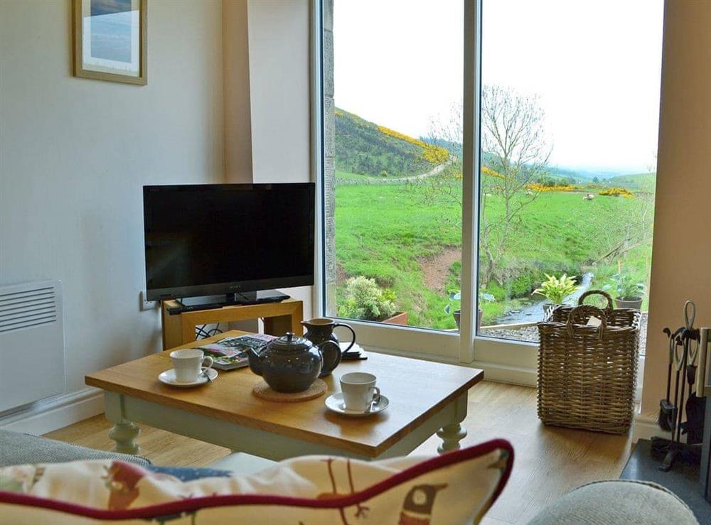Cosy living area with wood burner and superb views (photo 2) at Bridge Cottage, 